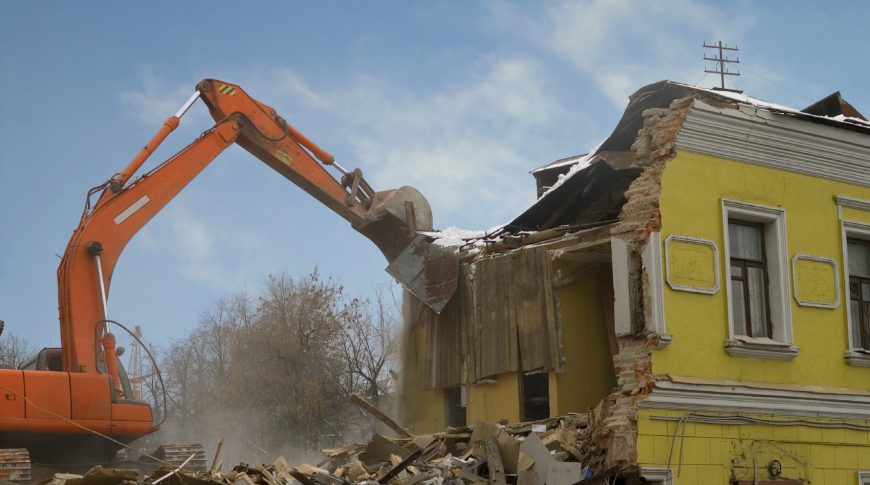 Demolition of an old house with power shovel